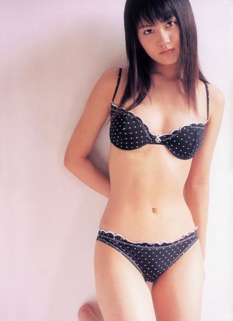 Adorably sweet asian beauty is terribly cute in a pink swim suit