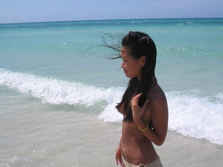Super gorgeous Asian girl having fun in the beach