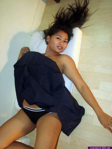 Shy college student lifting her school skirt to show her hairless slit