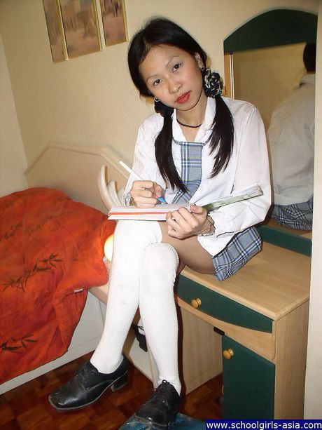 Pigtailed student stripping naked and spreading her pussy lips