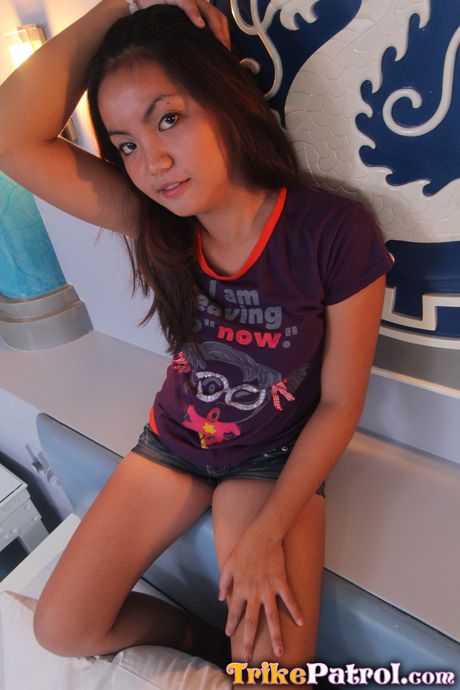 Asian teen Ashley strips and shows her trimmed pussy up close