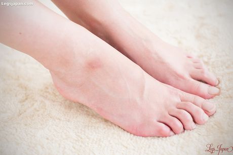 Skinny Asian teen Kamimoto Rio strips and gives a footjob to her lover