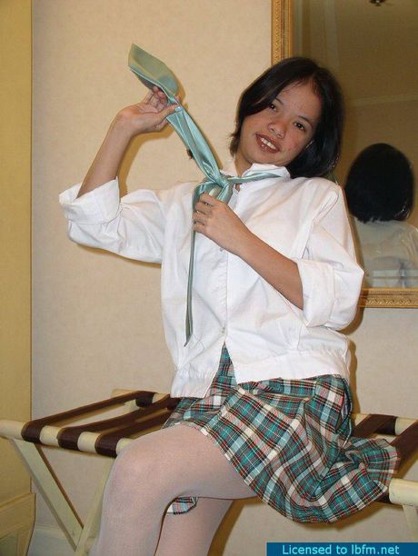Asian schoolgirl with tiny tits strips and shows her pussy in a solo