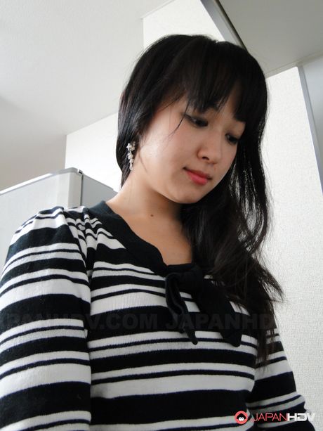 Platinum Japanese babe Risa Kurokawa strips and displays her tiny tits in a solo